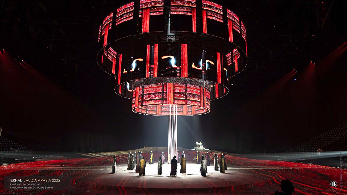 A monumental kinetic chandelier of three concentric LED rings.