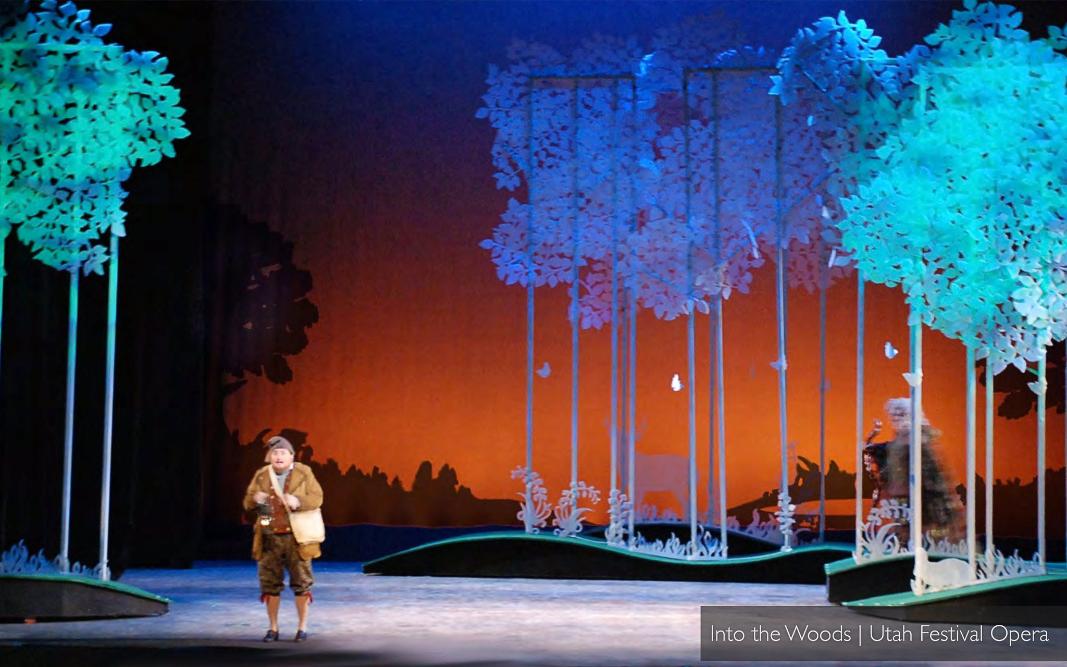 Patrick Larsen's Into the Woods at Utah Festival Opera — paper-cut canopy of trees lit from above over a small island stage.