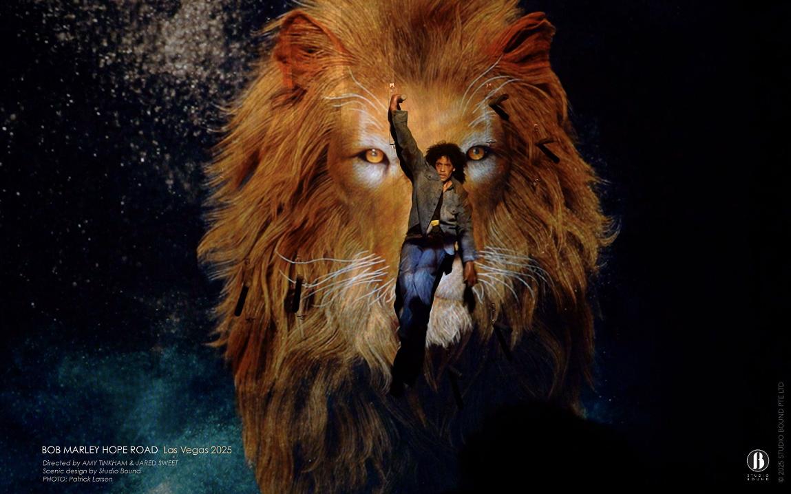 The Lion of Judah composited above a young performer reaching skyward — the iconographic register Hope Road moves into as the story turns from street to spirit. Scenic design by Studio Bound. Photo: Patrick Larsen.
